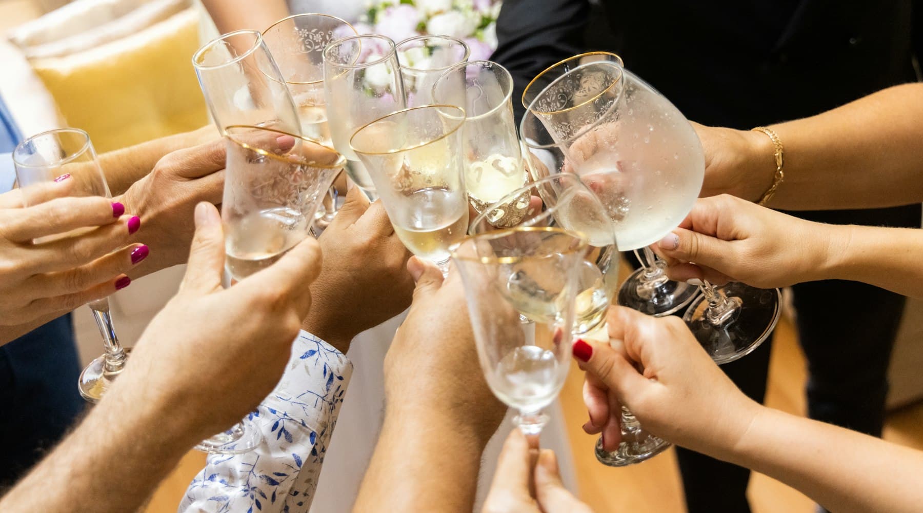Guests raising glasses together during a celebration